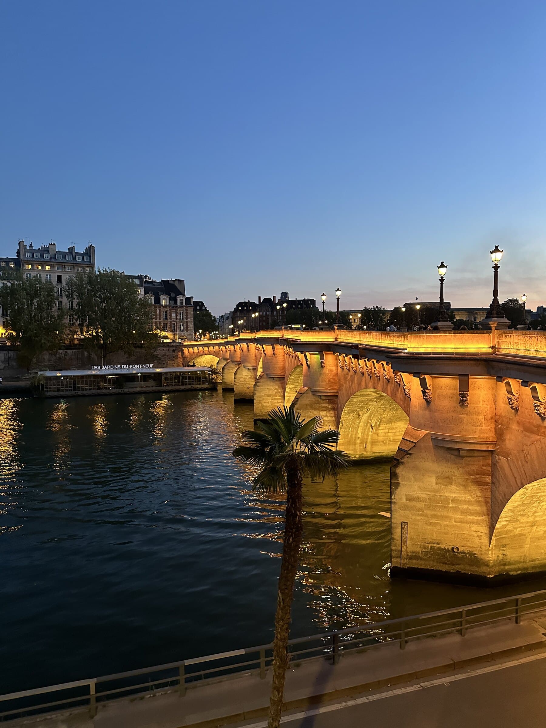Paris bridge and Seine at blue hour.